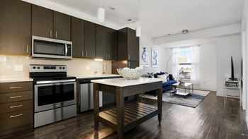 a kitchen with stainless steel appliances and a table